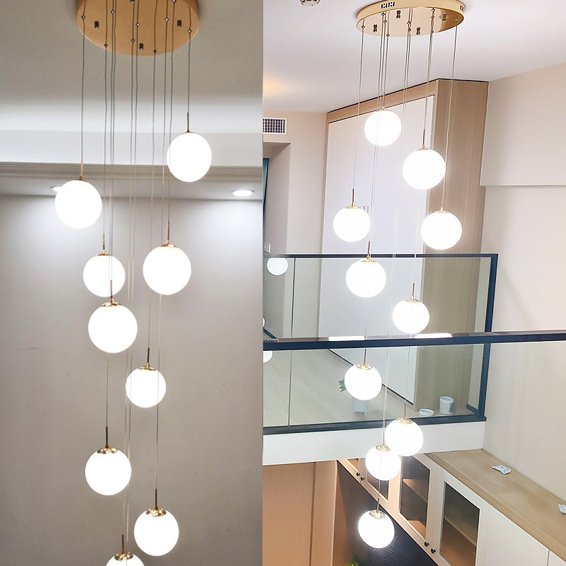 Minimalist Gold Multi-Pendant Ceiling Light With Cream Glass Bubbles And White Staircase Suspension