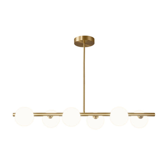 Sleek And Elegant Linear Gold Island Pendant Lighting With Spherical Glass Shades For Dining Table