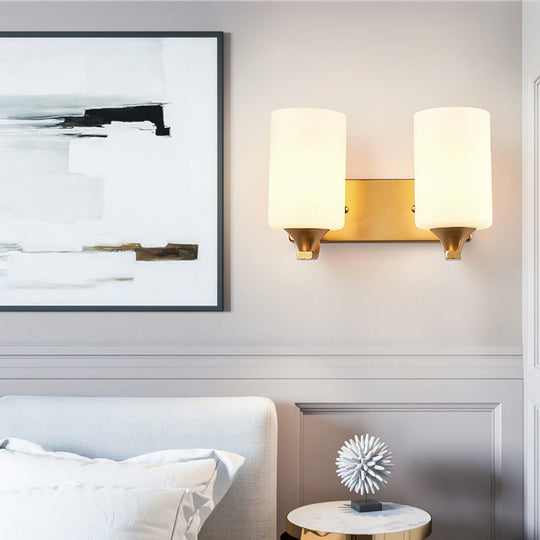 Traditional 2-Bulb Gold Wall Lamp With Milky Glass Cylindrical Fixture