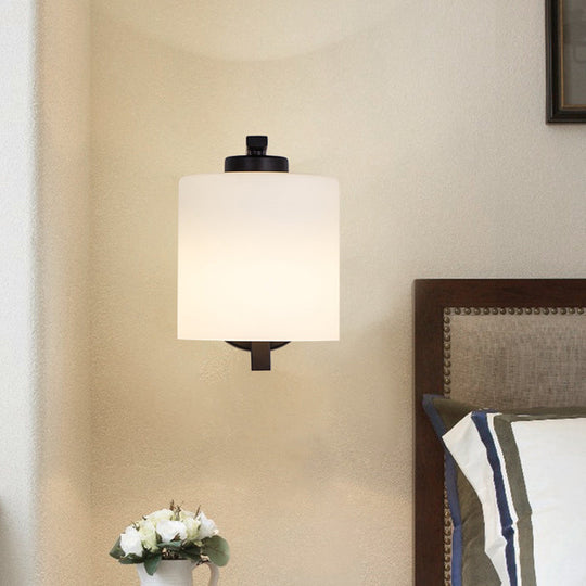 Black Wall Sconce With Ivory Glass Cylinder And Curved Arm - 1-Light Mounted Lamp