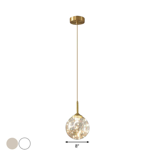 Sleek Brass Sphere Led Pendant Lamp For Modern Dining Rooms