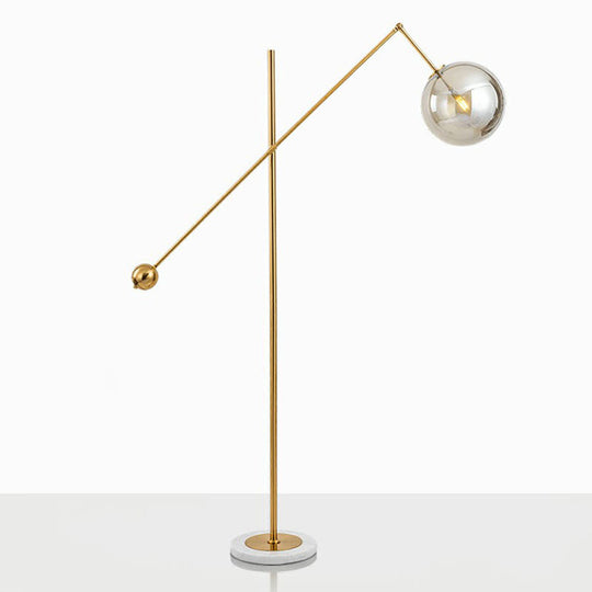 Postmodern Brass Plated Balance Arm Floor Lamp With Glass Spherical Shade - Stylish Metal Stand-Up