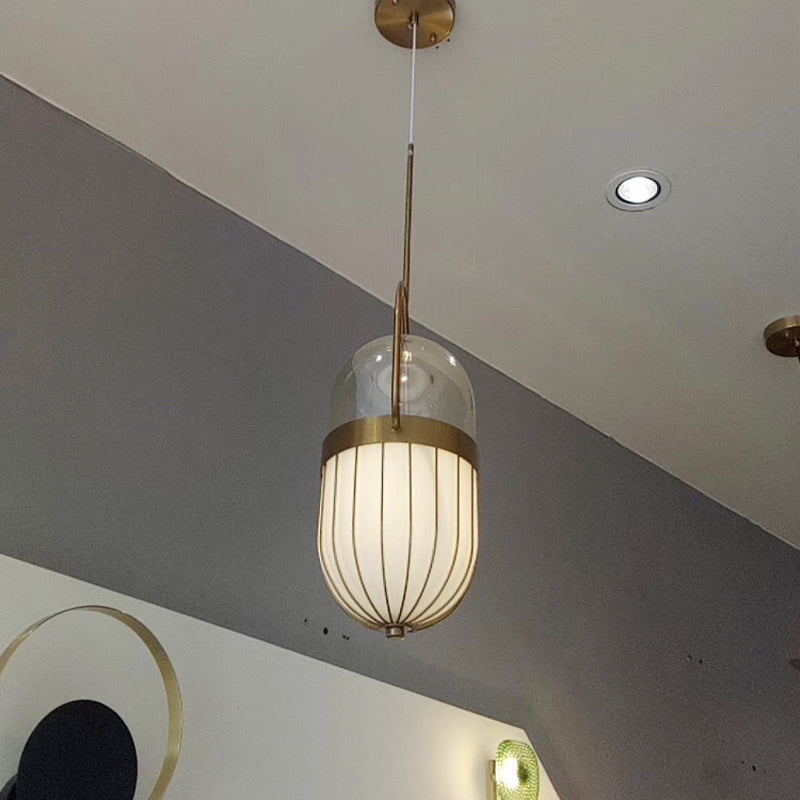 Postmoderne Pendelleuchte mit Pillenkapsel aus klarem und weißem Glas – 1-flammige Deckenleuchte für das Esszimmer in Gold