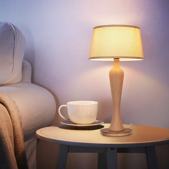 Modern Urn-Shaped Wood Desk Lamp In Beige - 1 Bulb Table Light With Drum Fabric Shade