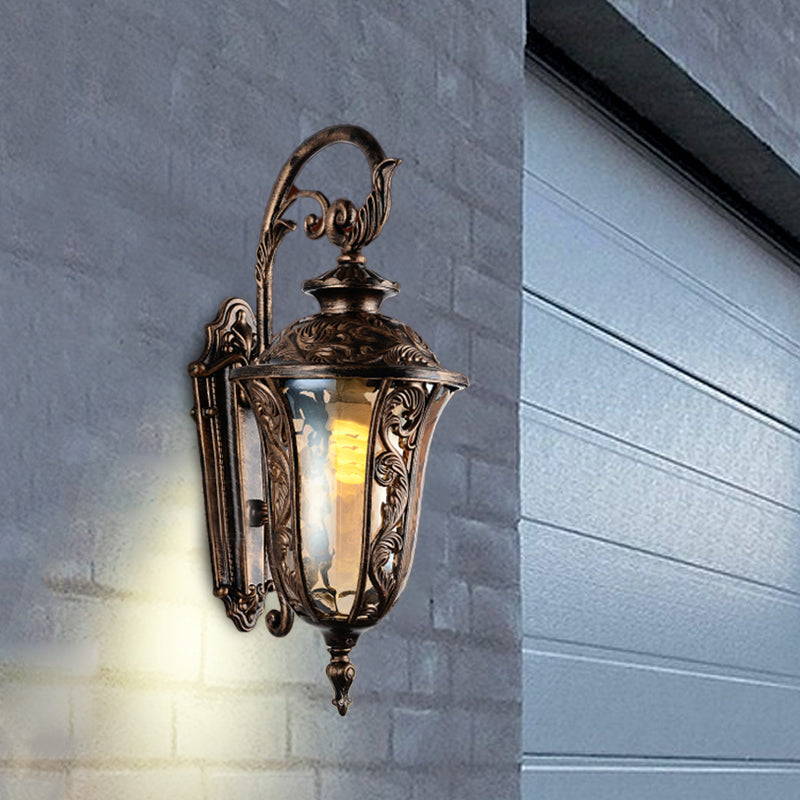 Bronze Metal Outdoor Wall Sconce With Curved Arm Amber Glass Shade - 1-Light Lamp