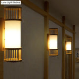 Asian Bamboo Cylinder Shade Wall Sconce Light In Beige - Stylish 1-Head Lamp For Stairway