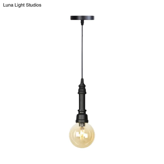 Industrial Black Finish Amber Glass Pendant Lamp With Pipe Suspension - 1-Light Ball/Capsule