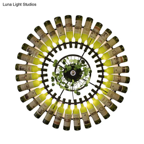 Industrial Led Wine Bottle Wall Sconce With Metal Fixture And Plant Accent In Black