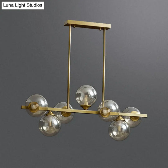 Mid-Century Modern Gold Metal Pendant With Spherical Amber Glass - Island Ceiling Light For Dining