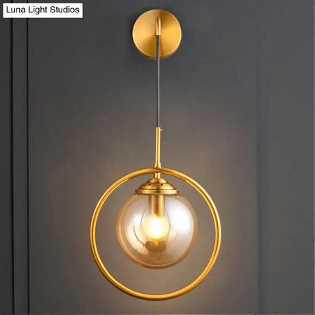 Modern Brass Wall Sconce With Glass Sphere Shade For Bedside Lighting