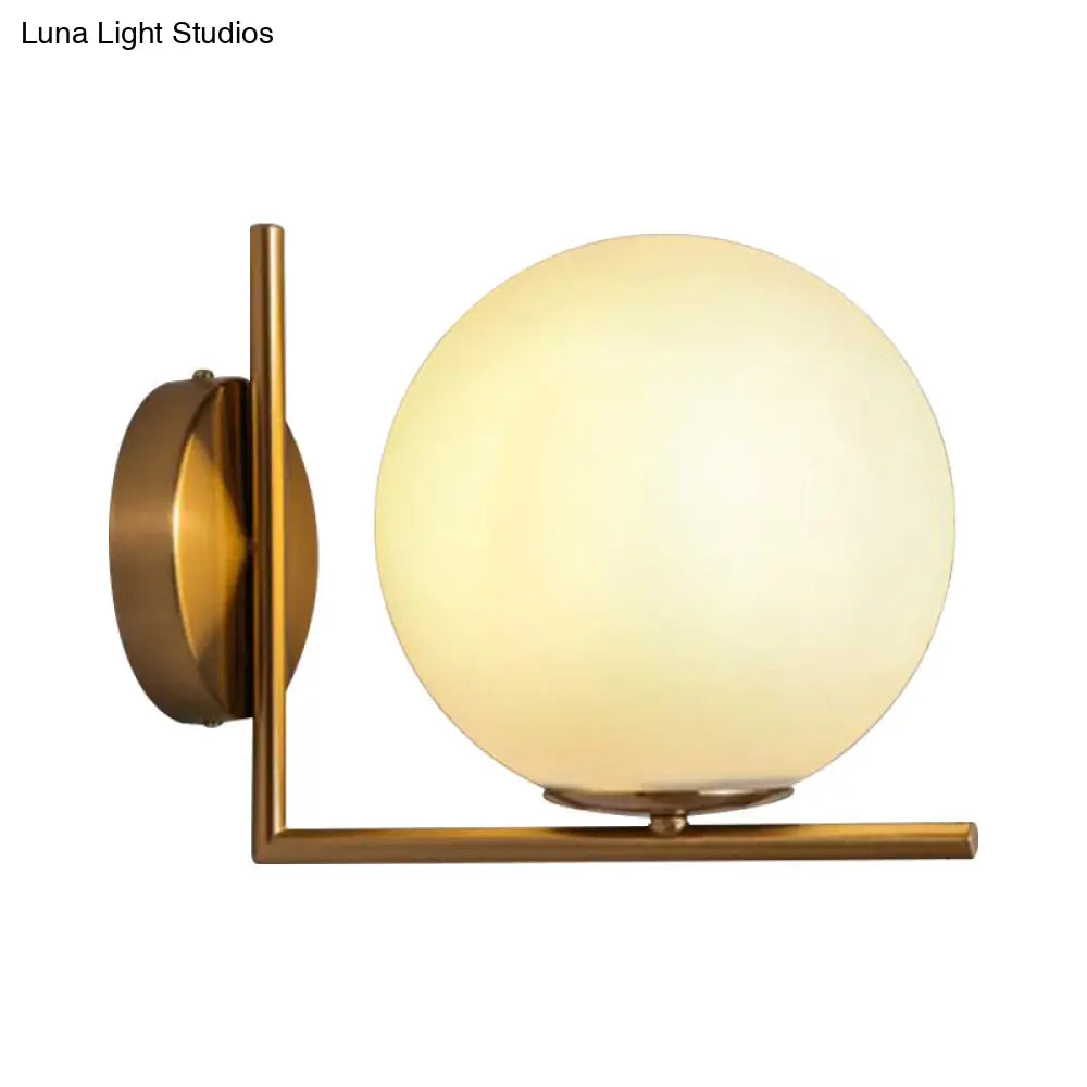 Modern Opal Glass Wall Sconce With Globe Shade And Gold Accent For Washroom Lighting