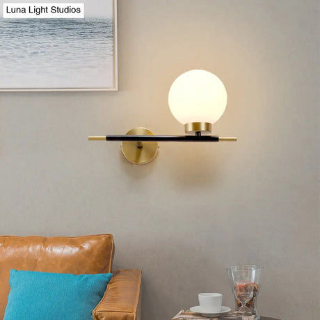 Post-Modern White Glass Sphere Wall Sconce With Brass Finish - 1/2 Bulbs
