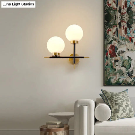 Post-Modern White Glass Sphere Wall Sconce With Brass Finish - 1/2 Bulbs