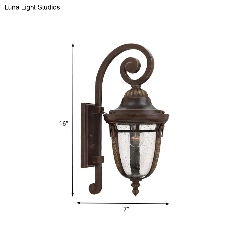 Rustic Bronze Scrolling Arm Metal Wall Lamp - 1 Light Outdoor Sconce With Seedy Glass Shade