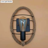 Rustic Indoor Wall Light With Wagon Wheel Design And Rope Shade
