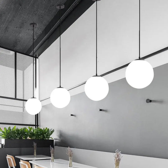 Sleek Black Sphere Restaurant Pendant Light With Cream Glass Shade - Simple Ceiling Hang Lamp
