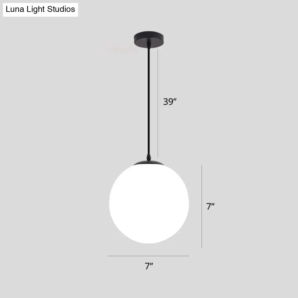 Sleek Black Sphere Restaurant Pendant Light With Cream Glass Shade - Simple Ceiling Hang Lamp
