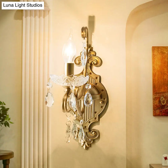 Traditional Crystal Candle Wall Sconce With Antiqued Brass Finish And Scroll Arm